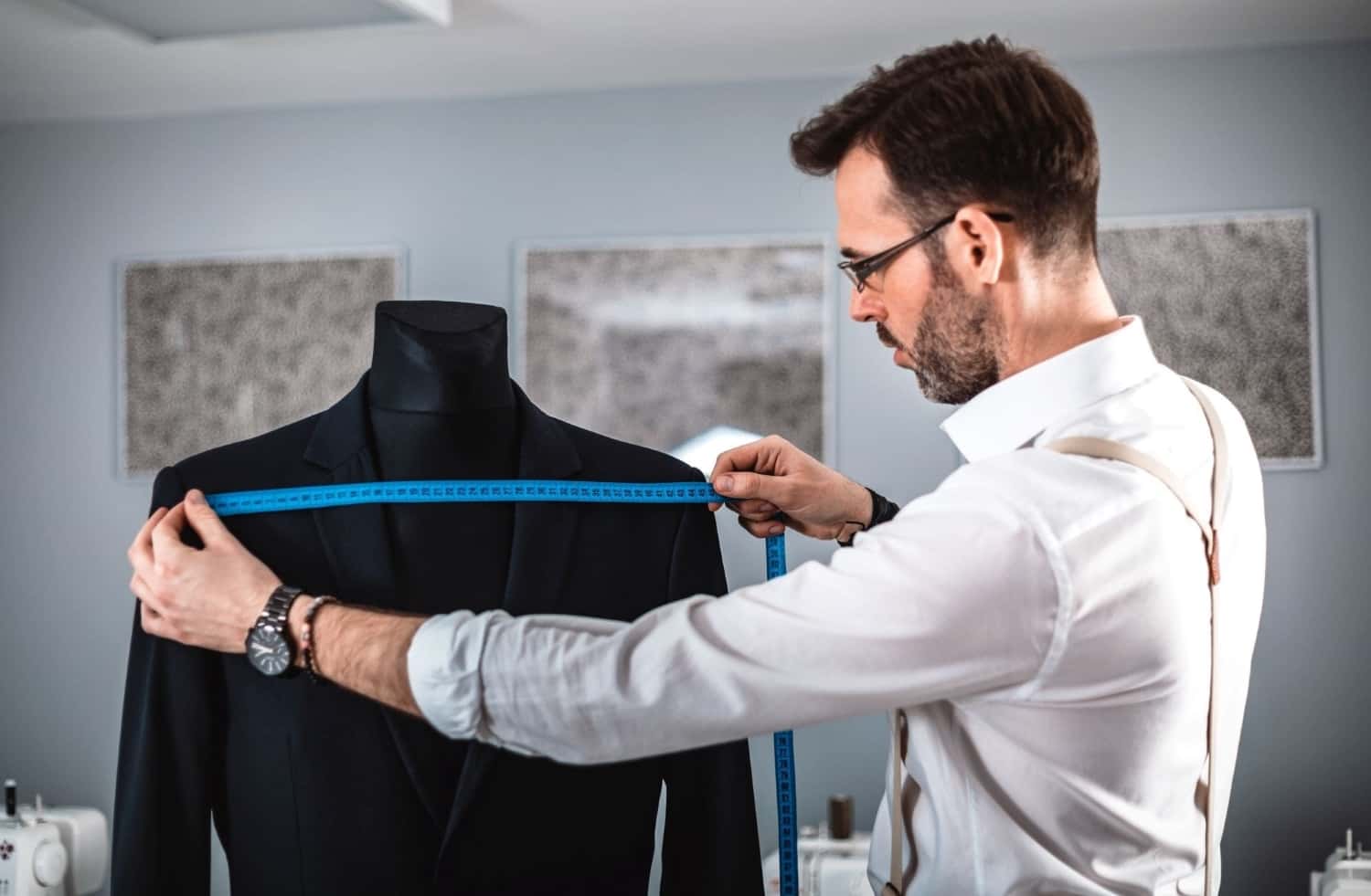tailor-measuring-jacket-suit-on-mannequin-at-fashi-MTW7Y2B.jpg